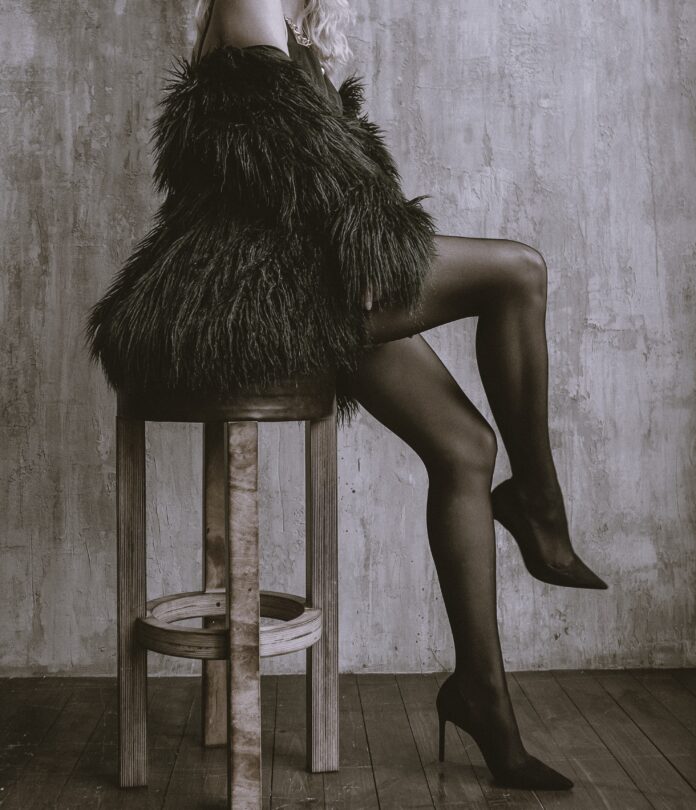 Woman posing in a fur coat.