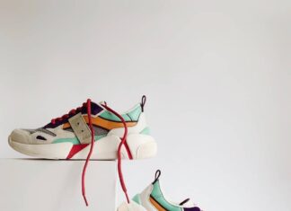 pair of white-and-orange athletic shoes on white box