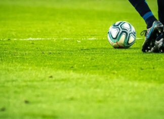 man playing soccer game on field