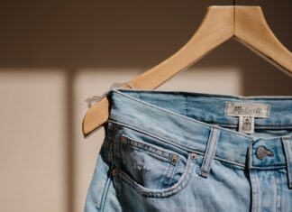 blue denim jeans on brown clothes hanger