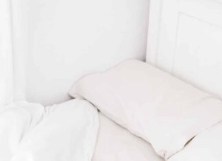 white portable speaker on bed