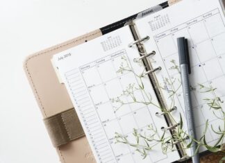 grey and black pen on calendar book