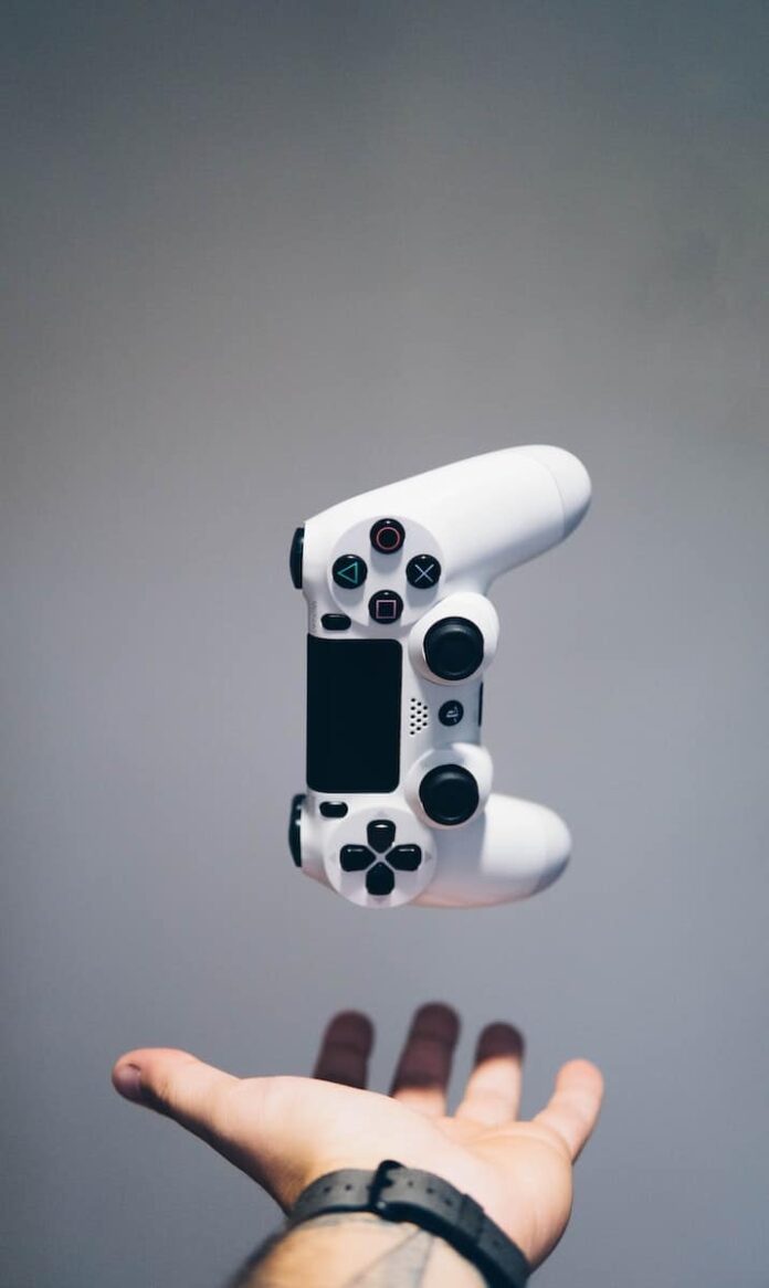 white Sony PS4 DualShock controller over person's palm