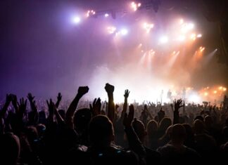 crowd facing lighted stage