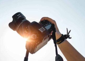 a person holding a camera up to take a picture