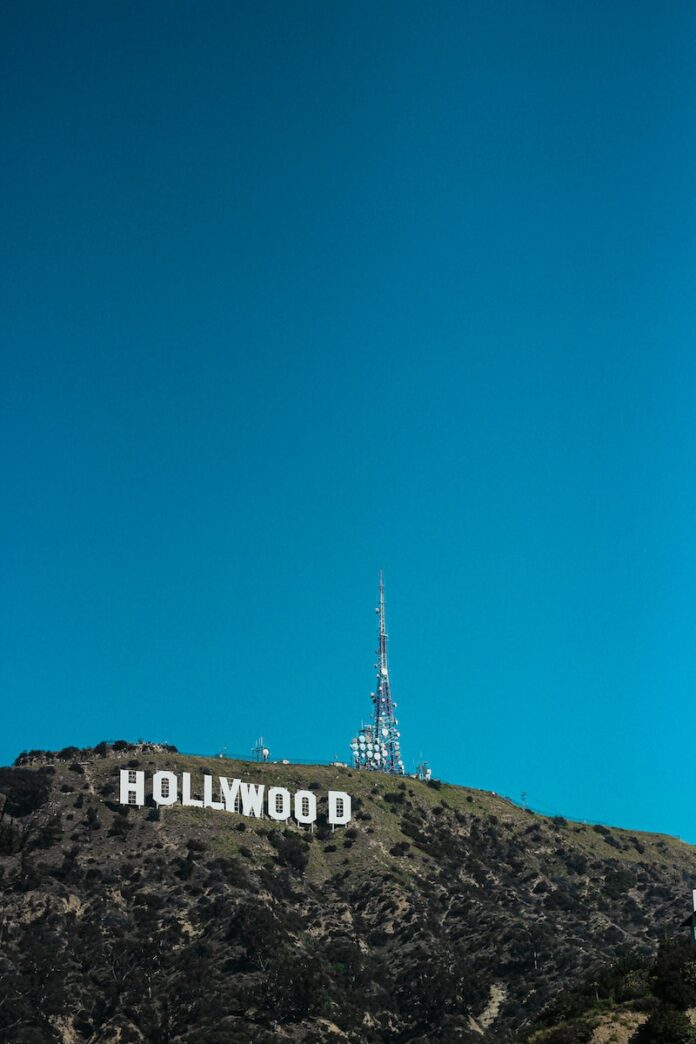 white tower on brown rock mountain under blue sky during daytime