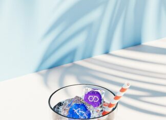 a glass filled with ice and candy on top of a table