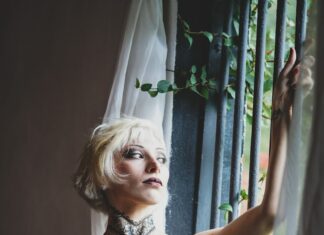 woman wearing black strapless dress inside room