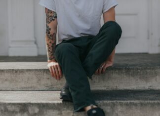 person sitting on gray concrete flooring