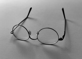 a pair of glasses sitting on top of a table
