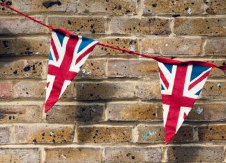 red and white star flag on brown brick wall