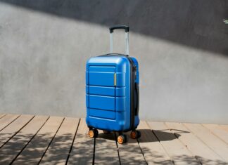 a blue suitcase sitting on top of a wooden floor