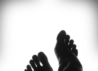 silhouette of person's feet against white background