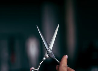 a person holding a pair of scissors in their hand