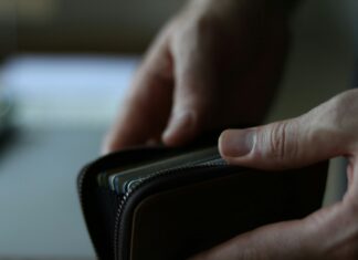 a person holding a wallet in their hand