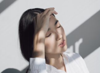 woman leaning on white table