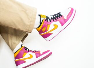 person in brown pants and blue white and pink nike sneakers