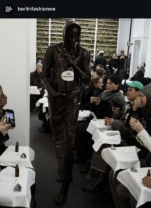Model walking the Richert Beil BFW AW26 runway with a bottle of "toxicant" after the shots had been poured